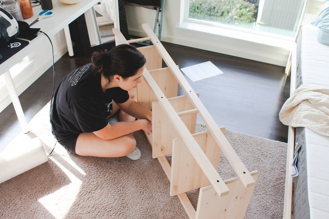 woman wearing black shirt fixing brown wooden rack